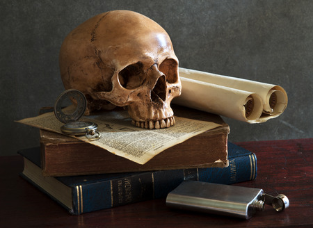 still life art photography on human skull skeleton with bookの写真素材