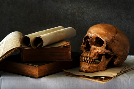 still life art photography on human skull skeleton with bookの写真素材