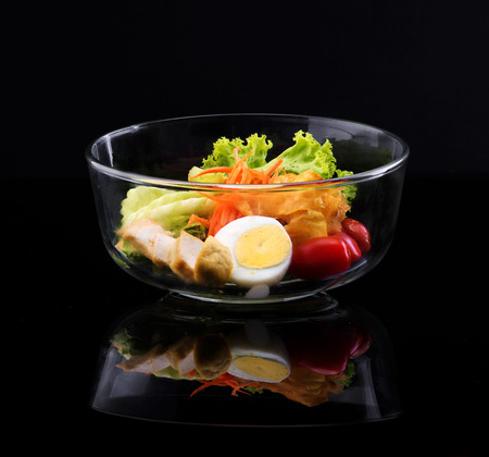 healthy salad in bowl isolate on blackの写真素材
