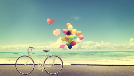 bicycle vintage with heart balloon on beach blue sky concept of love in summer and weddingの写真素材