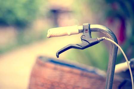 Detail of a Vintage Bicycle Handlebar Resting in the countryside  Street (vintage color toned image)の写真素材