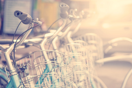 Detail of a Vintage Bicycle Travel Resting in the city Street with sunlight in morning (vintage color toned image)の写真素材