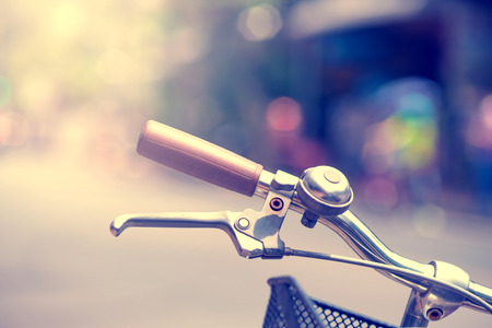 Detail of a Vintage Bicycle Handlebar Resting in the city  Street (vintage color toned image)の写真素材
