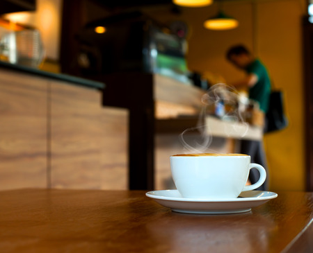 cup of coffee on table in cafeの写真素材