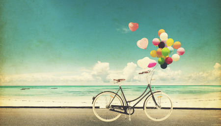 Paper Card of bicycle vintage with heart balloon on beach blue sky concept of love in summer and wedding honeymoonの写真素材