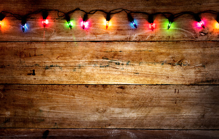 Christmas rustic background - vintage planked wood with colorful lights and free text spaceの写真素材