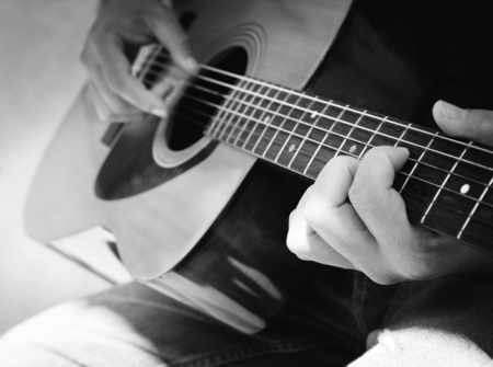 Details of performer man hands playing acoustic guitar musical, black and white photo- B&Wの写真素材