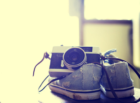 Vintage camera with Sneakers sun light backgroundの写真素材