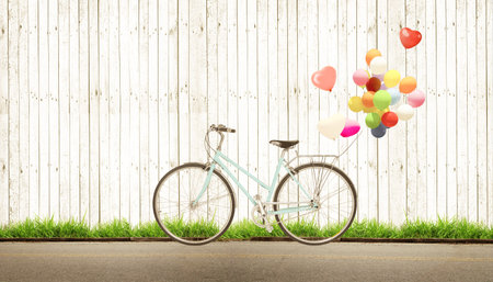 bicycle vintage with heart balloon concept of love in summer and wedding honeymoon, white wood backgroundの写真素材