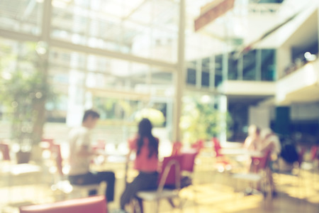 Blurred background of man and woman in cafeの写真素材