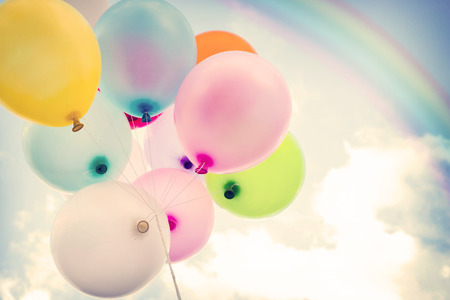 vintage colorful balloon with rainbow on blue sky concept of love in summer and valentine, wedding honeymoonの写真素材