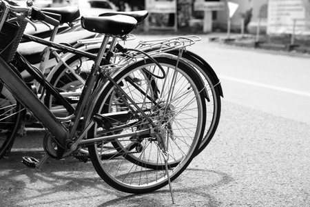Vintage bicycle on urban roadside. black and white effectの写真素材