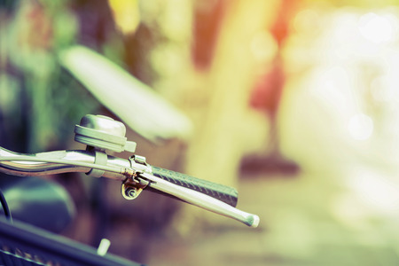 Detail of a vintage bicycle handlebar resting in the city Street - Blurred background (vintage filter effect )の写真素材