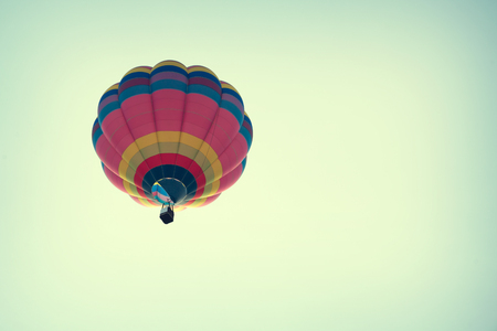 Multicolor hot air balloon on blue sky, vintage retro filter effectの写真素材