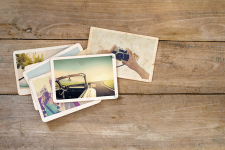 Travel photo album on wood table. instant photo of  camera - vintage and retro styleの写真素材