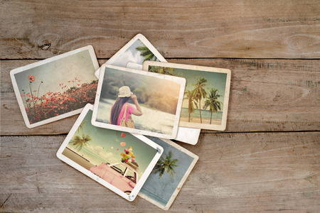 Summer photo album on wood table. instant photo of polaroid camera - vintage and retro styleの写真素材