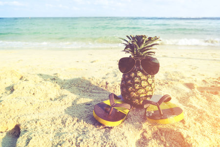 Hipster pineapple on beach - fashion in summer. vintage filter effect