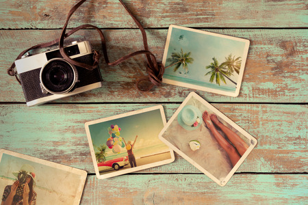 Summer photo album of journey honeymoon trip on wood table. instant photo of vintage camera - vintage and retro styleの写真素材