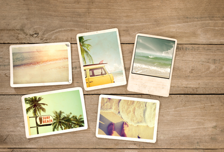 Photo album remembrance and nostalgia journey in summer surfing beach trip on wood table. instant photo of vintage camera - vintage and retro styleの写真素材