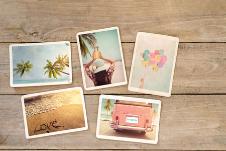 Photo album remembrance and nostalgia of journey honeymoon trip in summer on wood table. beach holiday relaxation. instant photo of vintage camera - vintage and retro stylesの写真素材