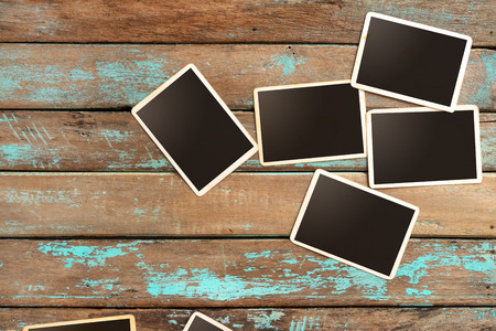 Empty old instant paper photo album on wood table - blank photo frame vintage and retro styleの写真素材