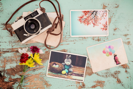 Photo album in remembrance and nostalgia of Happy easter day in spring on wood table. instant photo of vintage camera - vintage and retro styleの写真素材