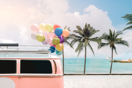 Vintage card of van with colorful balloon on beach blue sky concept of love in summer and wedding honeymoonの写真素材
