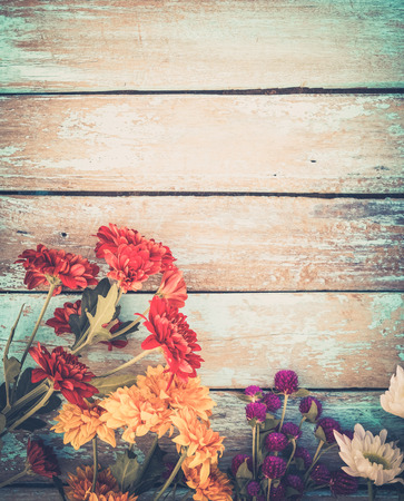 Colorful flowers bouquet on vintage wooden background, border design. vintage color tone - concept flower of spring or summer backgroundの写真素材