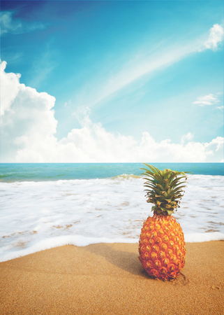 Ripe pineapples on the sandy tropical beach with clear blue sky. Leisure in summer and Summer vacation concept. vintage color tone.の写真素材