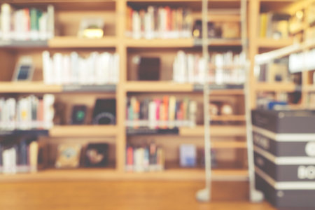 blurred bookshelf in library room for your background design - vintage color styles.