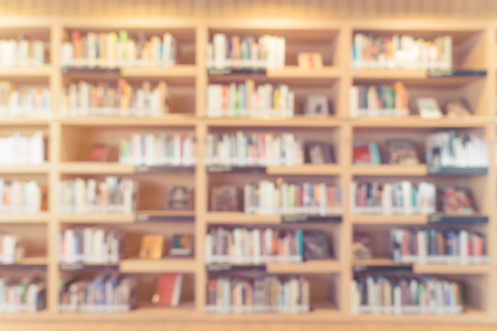 blurred bookshelf in library room for your background design - vintage color styles.の写真素材
