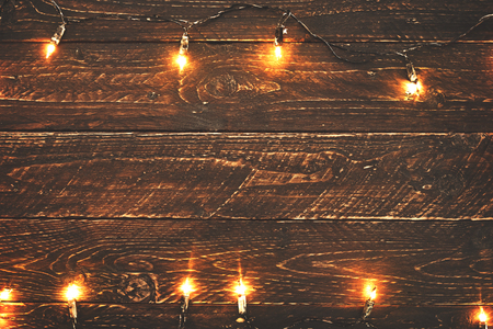 Christmas lights bulb on wood table. Merry christmas (xmas) background. topview, border design - rustic and vintage stylesの写真素材