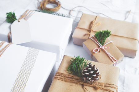 Christmas background - Craft and handmade Christmas present (gift boxes) and rustic decoration. Vintage style. Selective focus and shallow.の写真素材