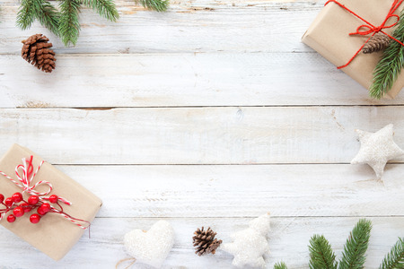 Christmas background with decorations and handmade gift boxes on white wooden board. Creative Flat layout and top view composition with border and copy space design.の写真素材