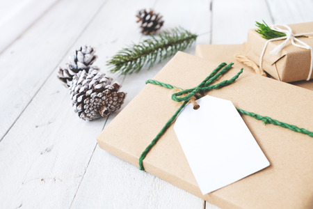 Christmas background - Craft and handmade Christmas present (gift boxes) with tag. Vintage style. Selective focus and shallow.の写真素材