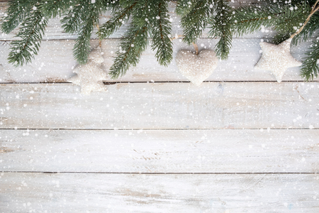 Christmas background - fir leaves and decoration rustic elements on white wood table with snowflake. Creative Flat layout and top view composition with border and copy space design.の写真素材
