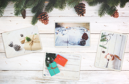 Photo album in remembrance and nostalgia in Christmas (winter season) on wood table. photo of retro camera - vintage and retro style, topviewの写真素材