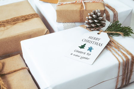 Christmas background - Craft and handmade Christmas present (gift boxes) with tag. Vintage style. Selective focus and shallow.の写真素材