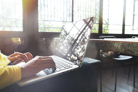 Hipster woman using mobile laptop. young businesswoman working at coffee shop. freelance worker concept. Film color tone. Flares and light effect background.の写真素材