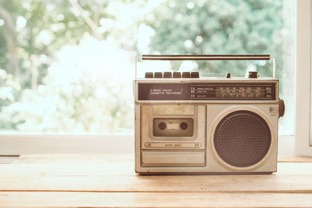 Photo of memorie and nostalgia. vintage radio or cassette reccorder in house. vintage color tone.の写真素材