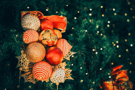 Christmas tree with ball decoration with light on tree. Christmas and New Year holiday background. vintage color tone. close-up shot.の写真素材