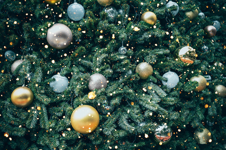Vintage Christmas tree with gold ball ornament and decoration, sparkle light. Christmas and New Year holiday background. vintage color tone.の写真素材