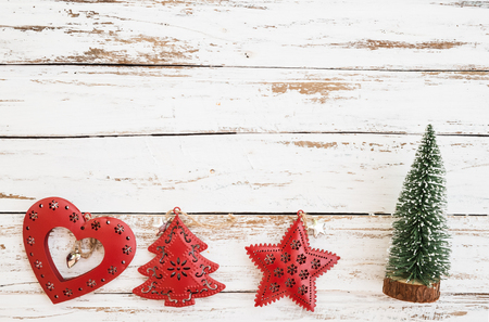 Christmas miniature tree, Xmas decoration and ornament on white wood background. vintage style, top view.の写真素材