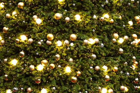 Vintage Christmas tree with gold ball ornament and sparkle light. Christmas and New Year holiday background.の写真素材
