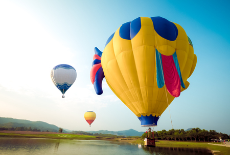 Fantasy hot air balloon flying on hillside. travel and air transportation concept - balloon carnival in Thailandの写真素材