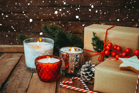 Christmas candle at night in merry christmas and New year holiday with rustic handmade present, gift boxes. vintage color tone image.の写真素材