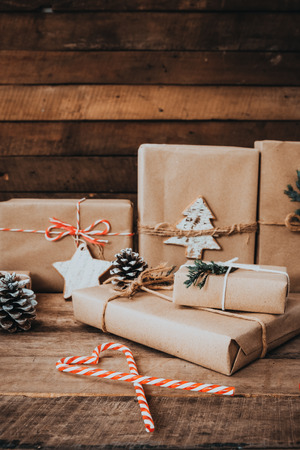 Christmas handmade present with tag for Merry Christmas and New year holiday. Rustic craft gift boxes. vintage color tone image.の写真素材