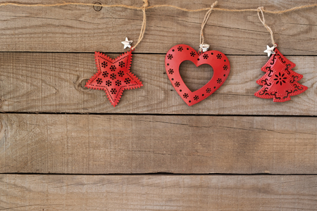 Rustic Christmas decorative, Xmas ornament hanging  on wood wall background. vintage style.の写真素材