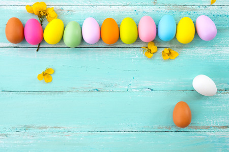 Colorful Easter eggs with flower on rustic wooden planksの写真素材