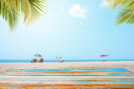 Top of wood table with seascape, palm leaf, calm sea and sky at tropical beach background. Empty...